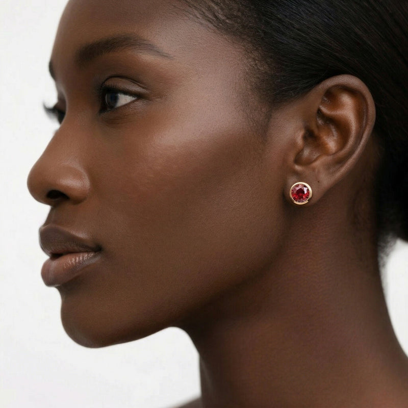 garnet birthstone stud earrings in rose gold finish — model view