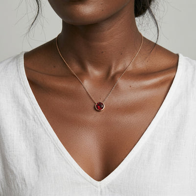 garnet birthstone necklace in rose gold finish — model view