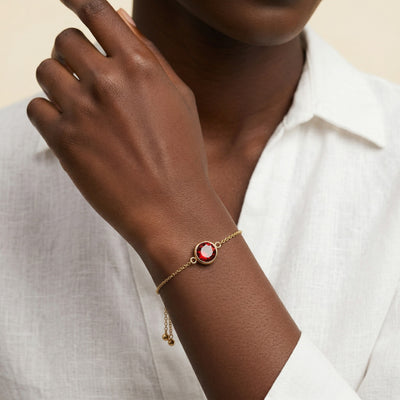 garnet birthstone bracelet in yellow gold finish — model view