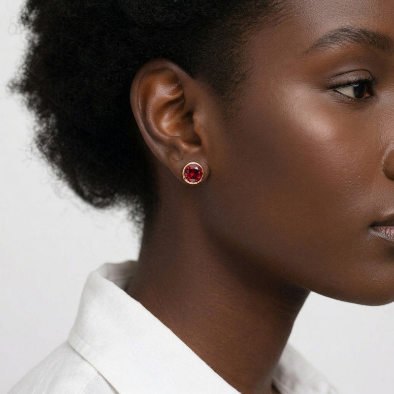 garnet birthstone stud earrings in yellow gold finish — model view