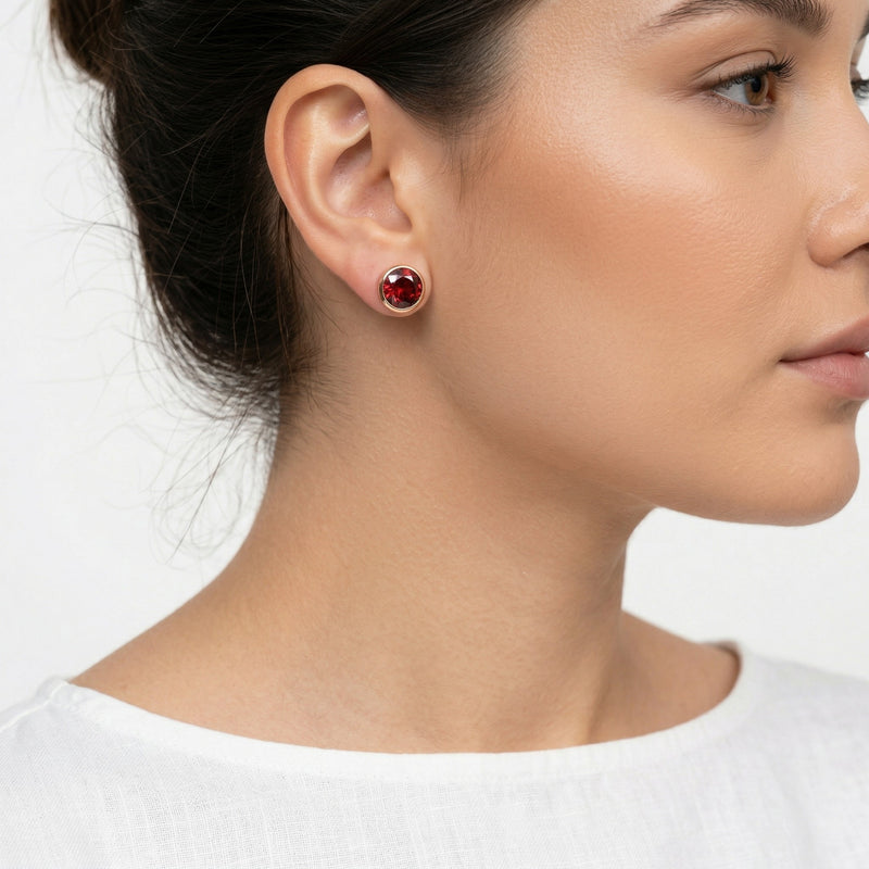 garnet birthstone stud earrings in rose gold finish — model view
