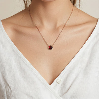 garnet birthstone necklace in rose gold finish — model view