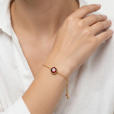 garnet birthstone bracelet in yellow gold finish — model view