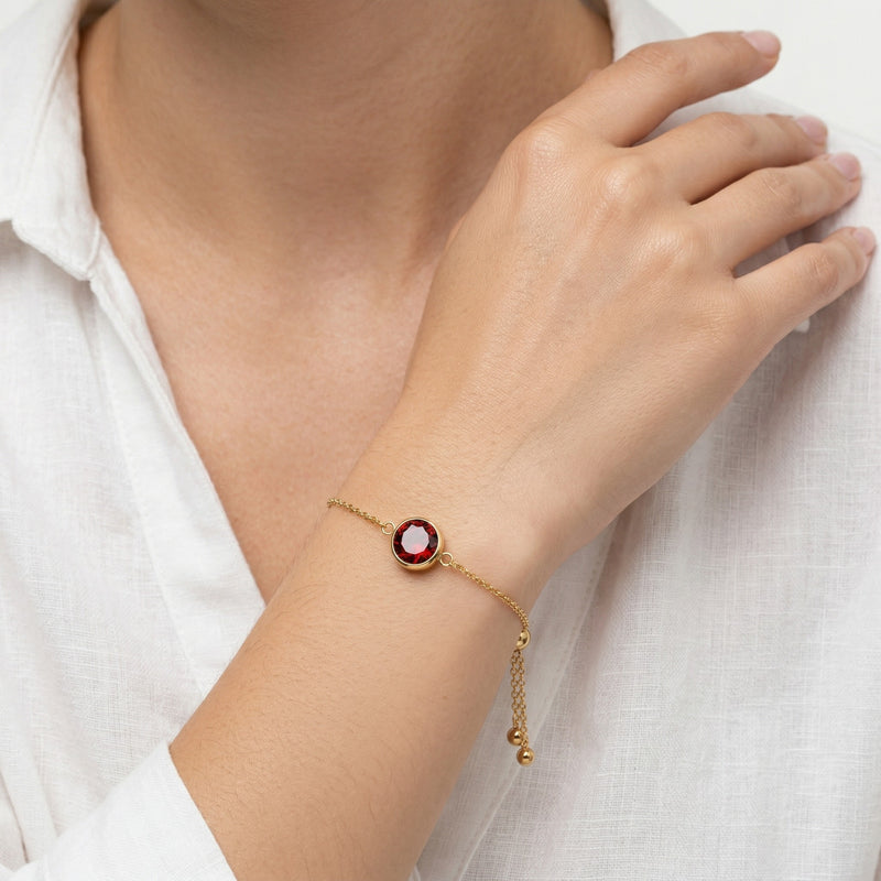garnet birthstone bracelet in yellow gold finish — model view