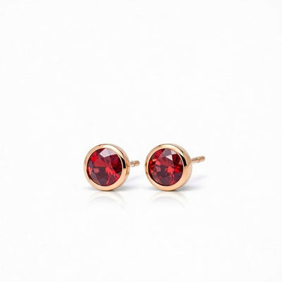 garnet birthstone stud earrings in rose gold finish — side view