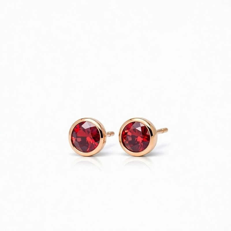 garnet birthstone stud earrings in rose gold finish — side view