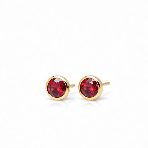 garnet birthstone stud earrings in yellow gold finish — side view
