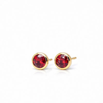 garnet birthstone stud earrings in yellow gold finish — side view
