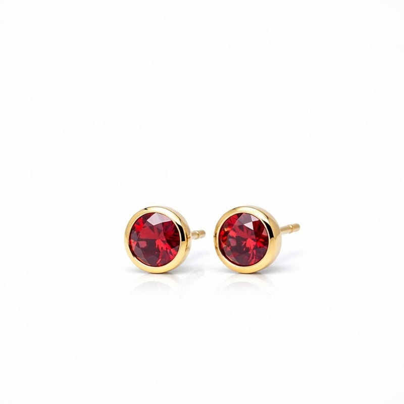 garnet birthstone stud earrings in yellow gold finish — side view