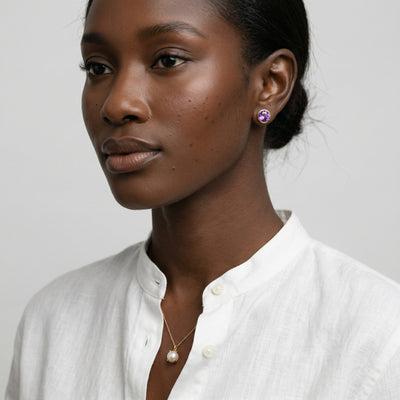 amethyst birthstone stud earrings in yellow gold finish — model view