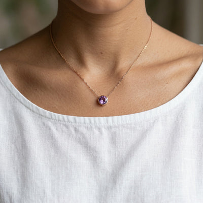 amethyst birthstone necklace in rose gold finish — model view