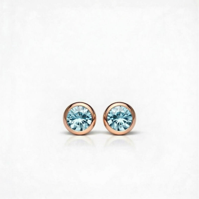 aquamarine birthstone stud earrings in rose gold finish — front view