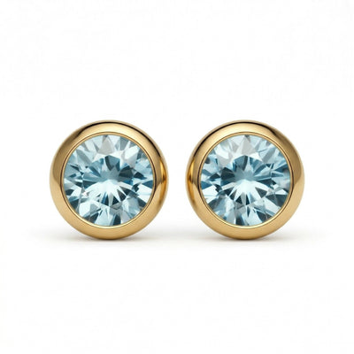 aquamarine birthstone stud earrings in yellow gold finish — front view