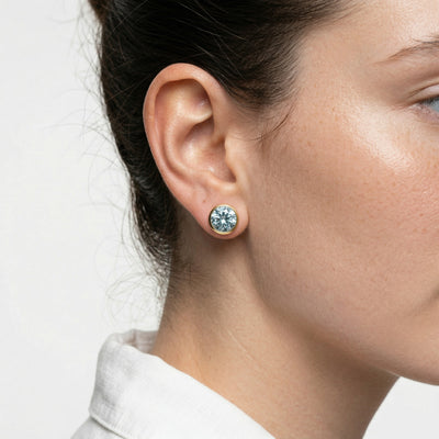 aquamarine birthstone stud earrings in yellow gold finish — model view
