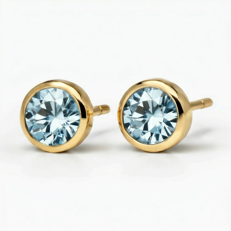 aquamarine birthstone stud earrings in yellow gold finish — side view