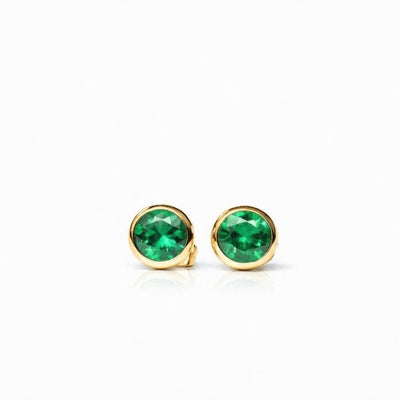 emerald birthstone stud earrings in yellow gold finish — front view