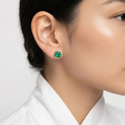 emerald birthstone stud earrings in rose gold finish — model view