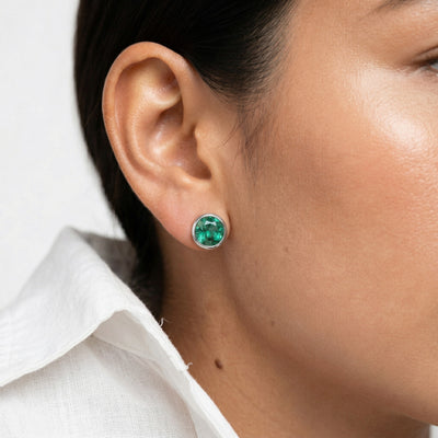 emerald birthstone stud earrings in white gold finish — model view