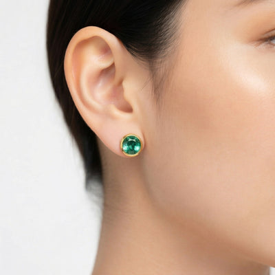 emerald birthstone stud earrings in yellow gold finish — model view