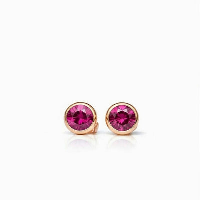 ruby birthstone stud earrings in rose gold finish — front view
