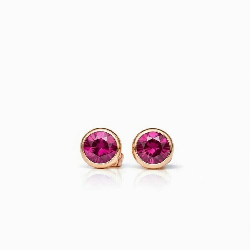 ruby birthstone stud earrings in rose gold finish — front view