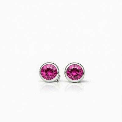 ruby birthstone stud earrings in white gold finish — front view