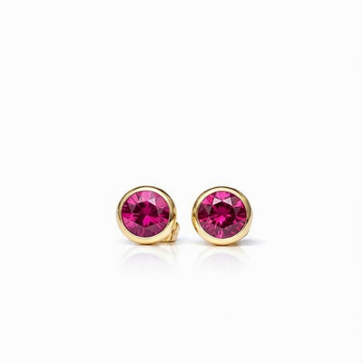 ruby birthstone stud earrings in yellow gold finish — front view