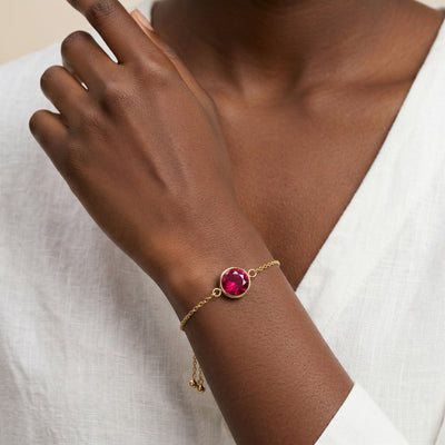 ruby birthstone bracelet in yellow gold finish — model view