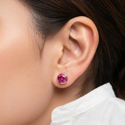 ruby birthstone stud earrings in yellow gold finish — model view