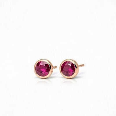 ruby birthstone stud earrings in rose gold finish — side view
