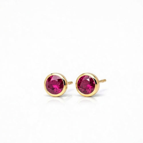 ruby birthstone stud earrings in yellow gold finish — side view