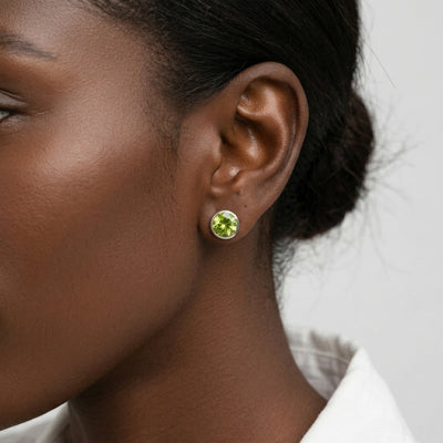 peridot birthstone stud earrings in white gold finish — model view