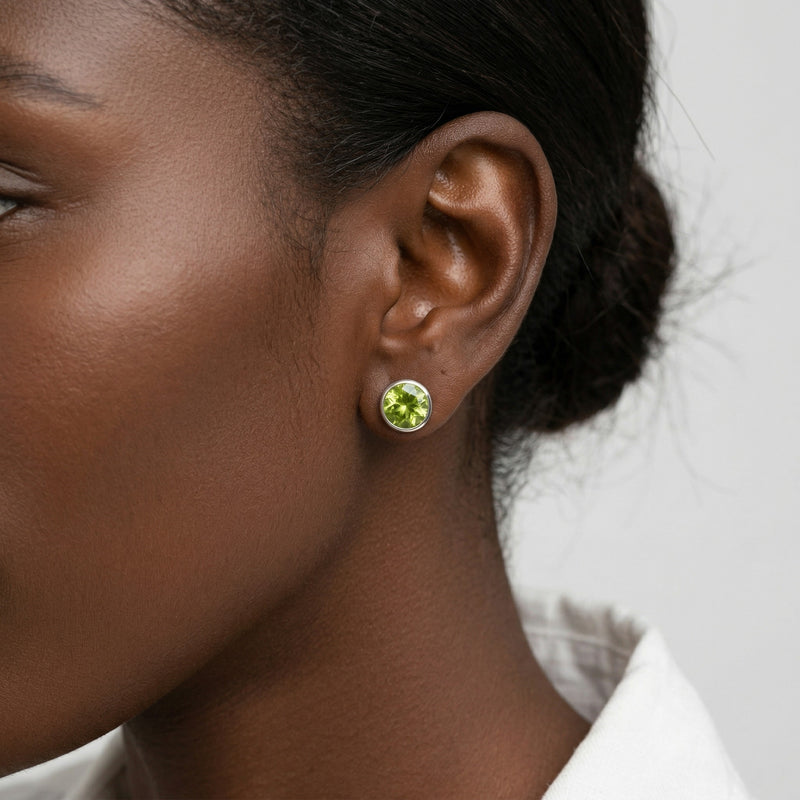 peridot birthstone stud earrings in white gold finish — model view