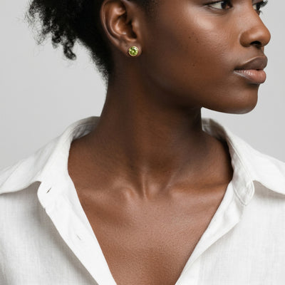 peridot birthstone stud earrings in yellow gold finish — model view