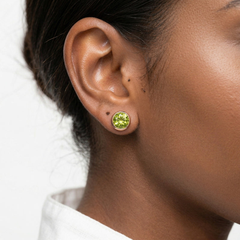 peridot birthstone stud earrings in rose gold finish — model view