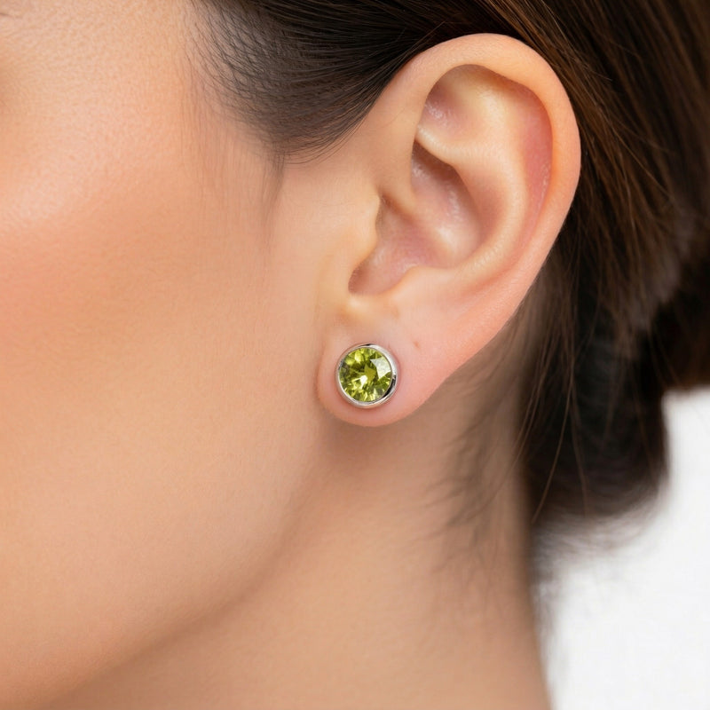 peridot birthstone stud earrings in white gold finish — model view