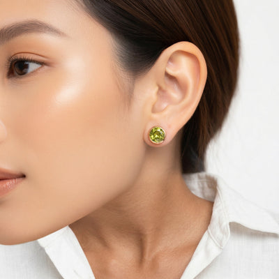peridot birthstone stud earrings in yellow gold finish — model view