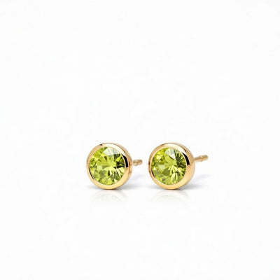 peridot birthstone stud earrings in yellow gold finish — side view