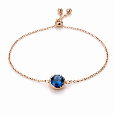 sapphire birthstone bracelet in rose gold finish — front view