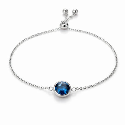 sapphire birthstone bracelet in white gold finish — front view