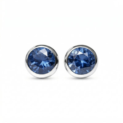 sapphire birthstone stud earrings in white gold finish — front view