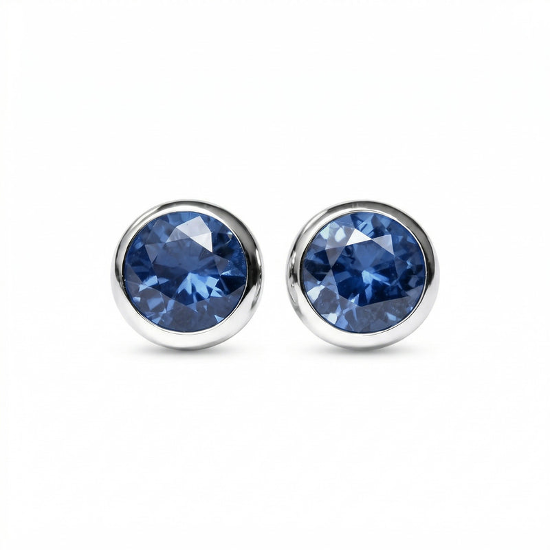 sapphire birthstone stud earrings in white gold finish — front view
