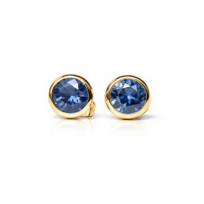 sapphire birthstone stud earrings in yellow gold finish — front view