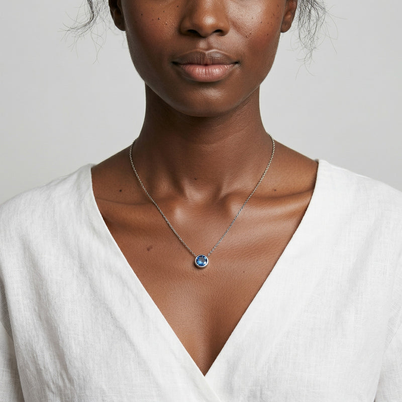 sapphire birthstone necklace in white gold finish — model view