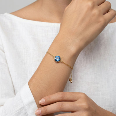 sapphire birthstone bracelet in yellow gold finish — model view