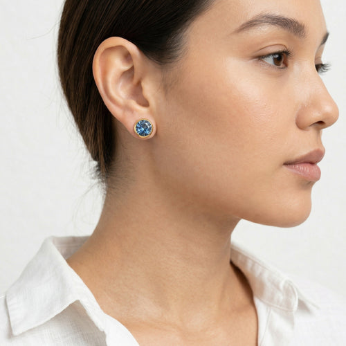 sapphire birthstone stud earrings in yellow gold finish — model view