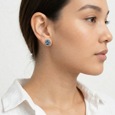 sapphire birthstone stud earrings in yellow gold finish — model view