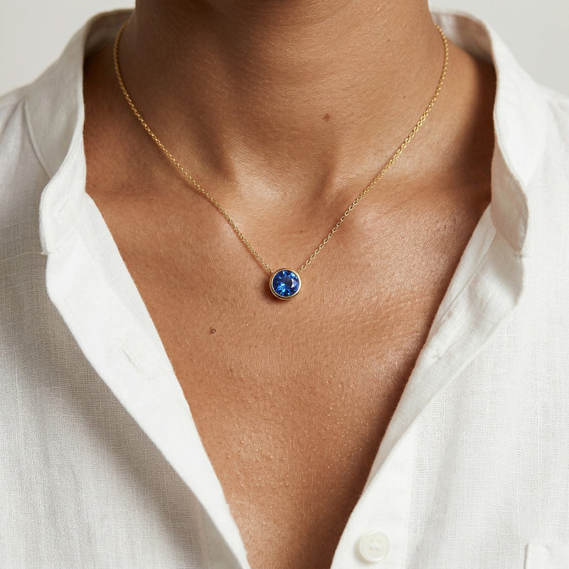 sapphire birthstone necklace in yellow gold finish — model view