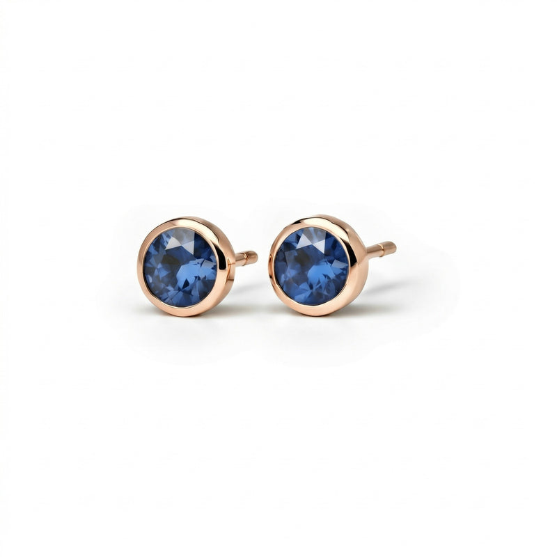 sapphire birthstone stud earrings in rose gold finish — side view
