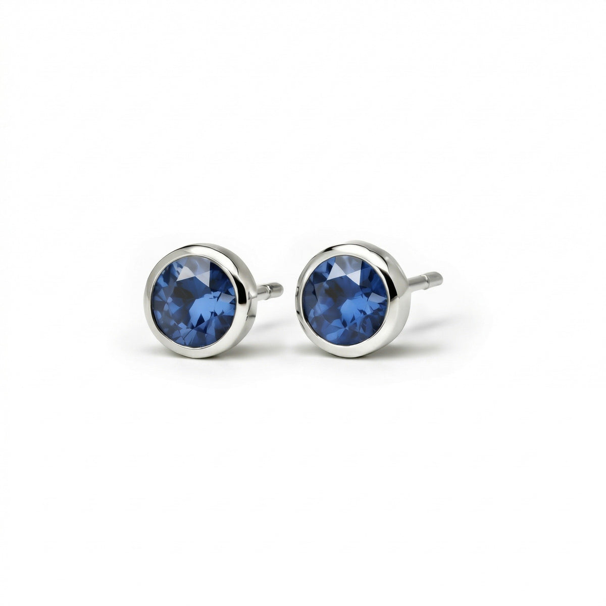 sapphire birthstone stud earrings in white gold finish — side view